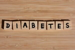 Diabetes, word in 3D wooden alphabet letters on a bamboo wood background.with copy space
